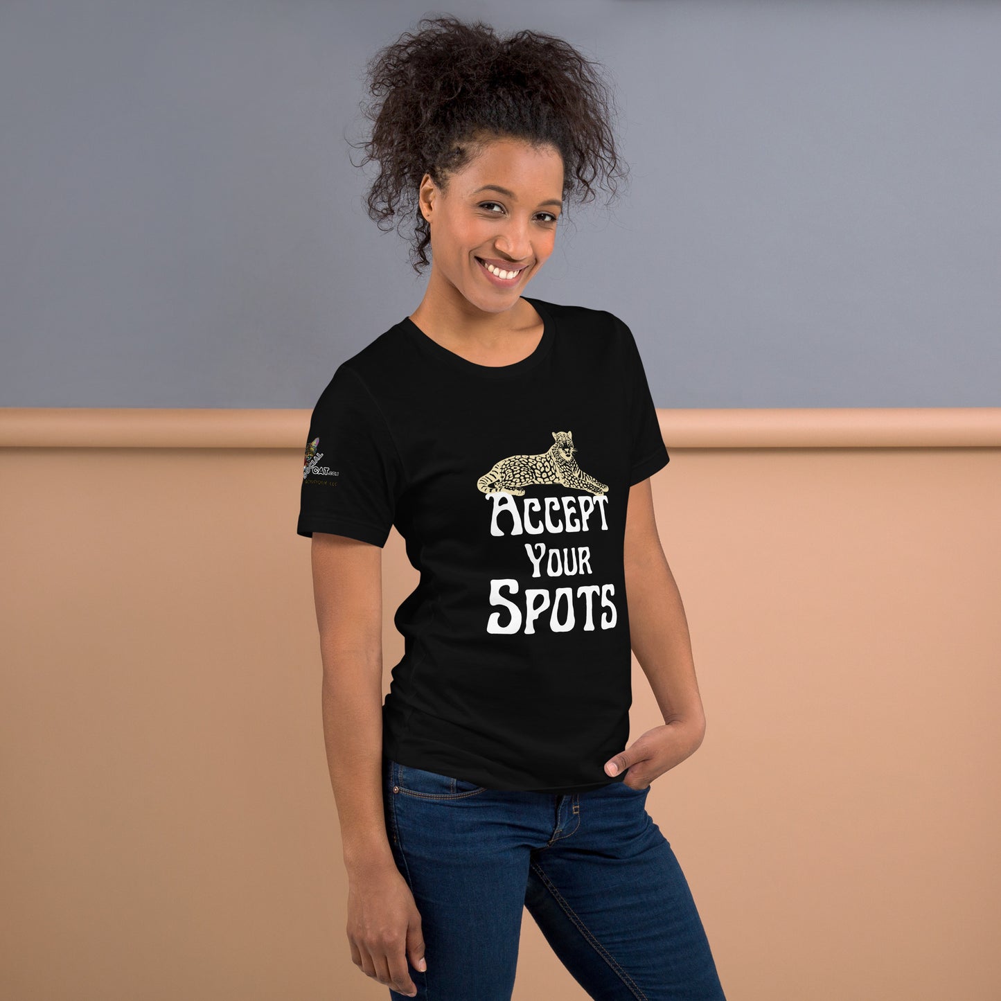 young black woman wearing black tshirt and jeans smiling inside the building says accept your spots
