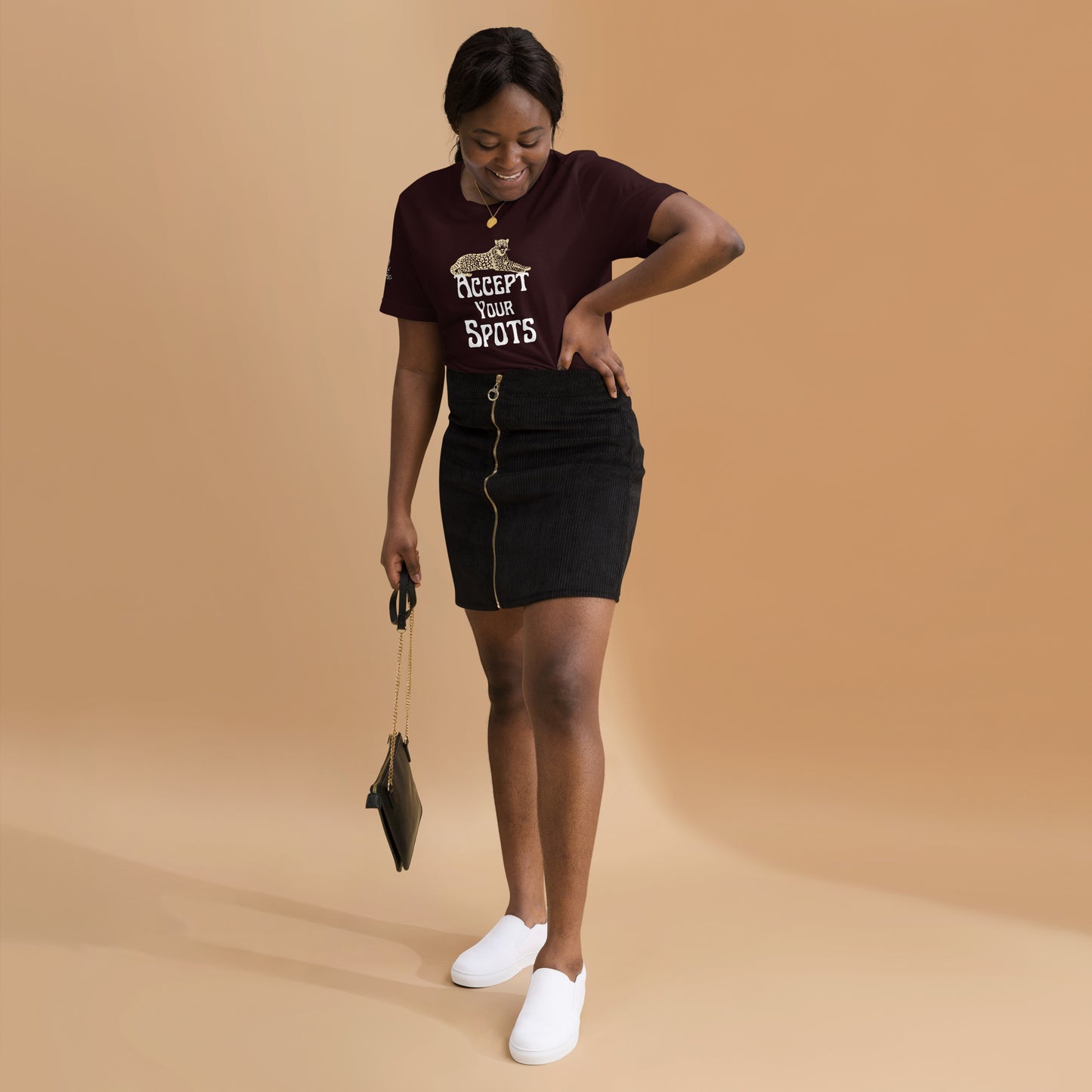 young black woman wearing oxblood black tshirt and black skirt in studio