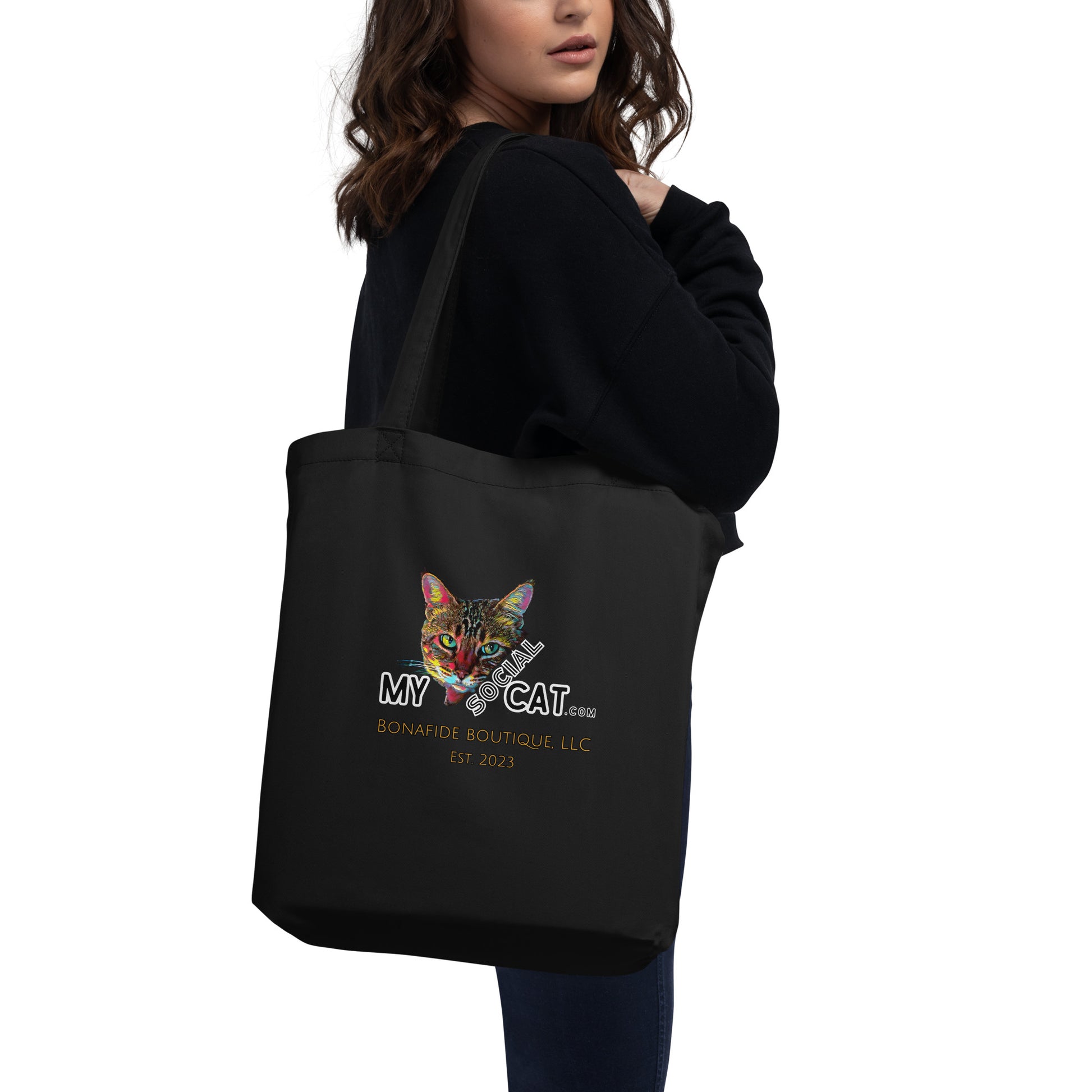 woman holding eco tote bag logo cat design back side