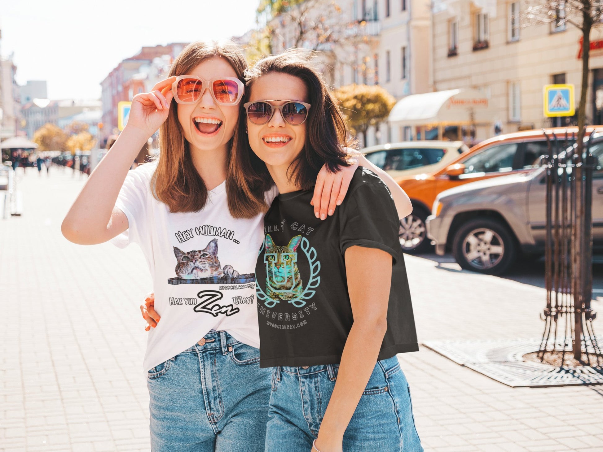 two happy  young sisters walking on the street in the city, wearing a  white with a cat face that says, hey hooman, haz you zen today, t-shirt and a black crop top, featuring a cat face with college emblem over its face that says, silly cat university, mysocialcat.com