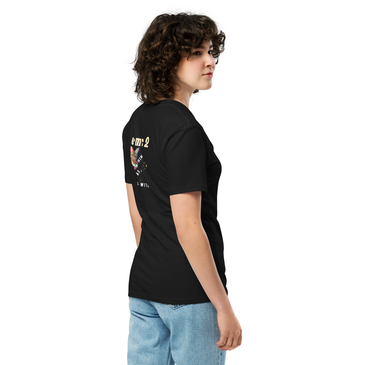 Person wearing a black t-shirt with a graphic design on the back, standing against a white background
