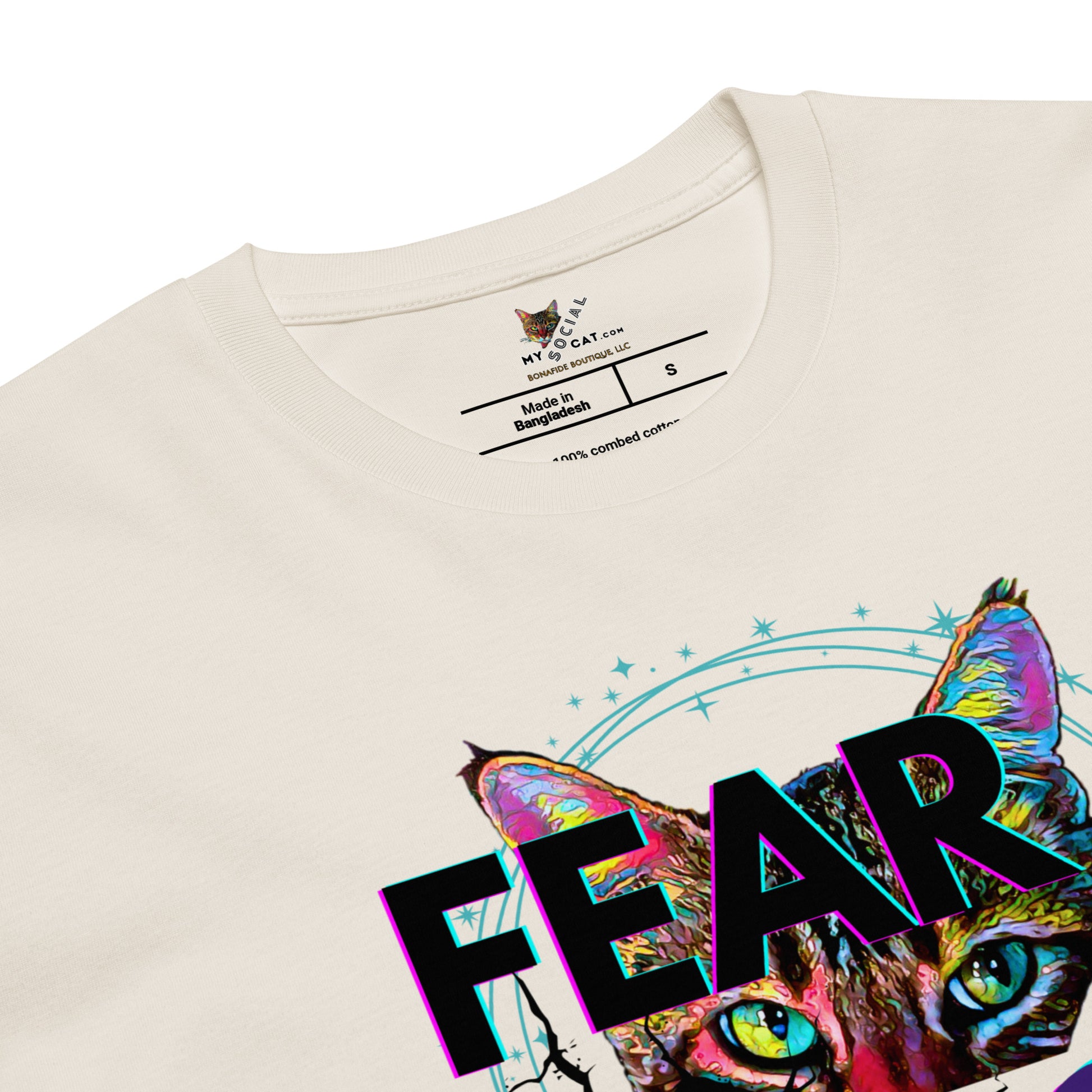 Beige t-shirt with a colorful cat graphic and 'FEAR' text on a white background