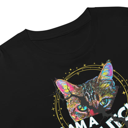 Close-up of a black short-sleeve T-shirt showing a colorful graphic print of a cat's face with neon pink, blue, yellow, and green tones, plus a gold circular star design and partial white text that says "I am a glitch in the matrix"